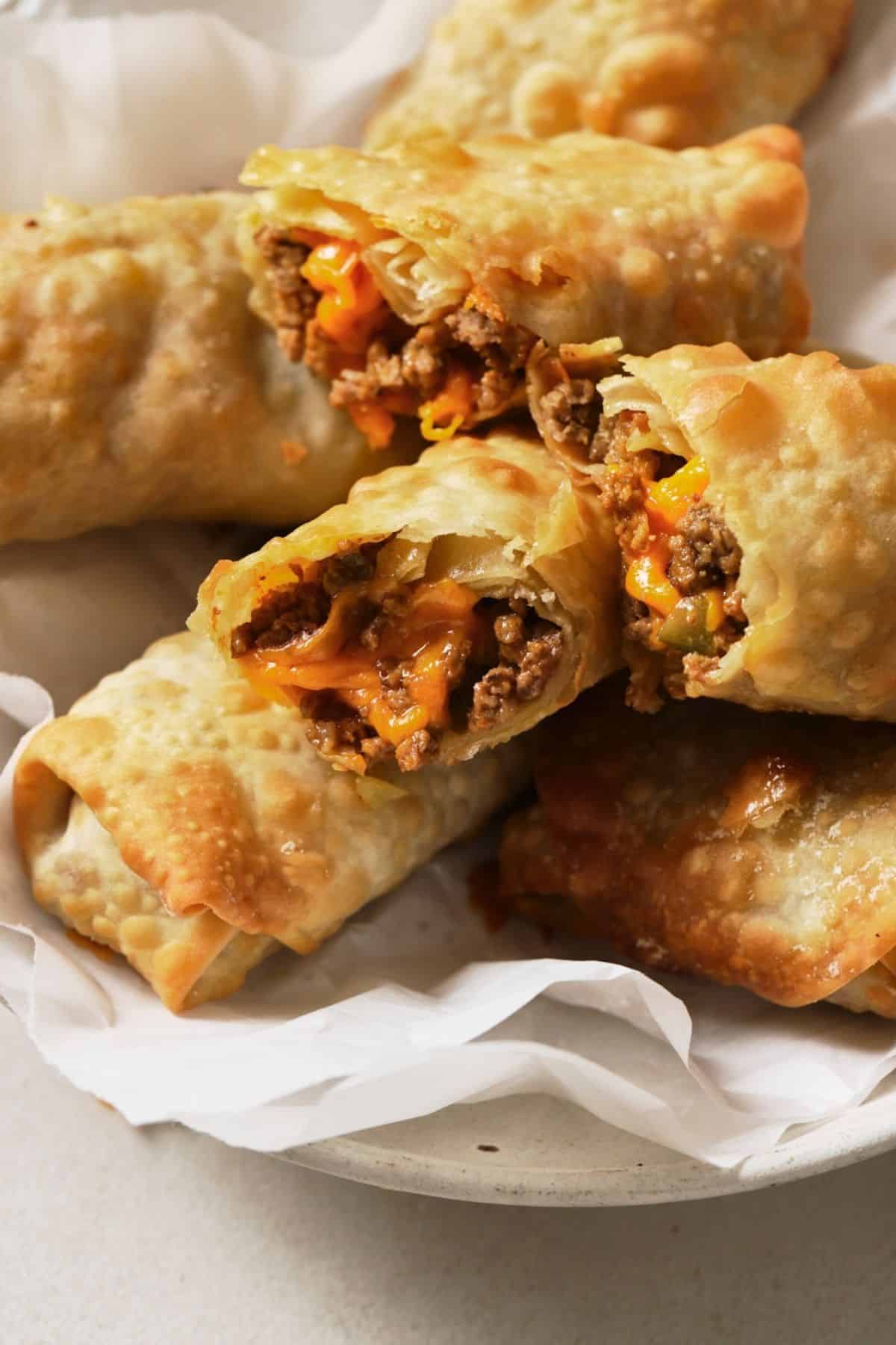 Air fryer cheeseburger egg rolls on a plate.
