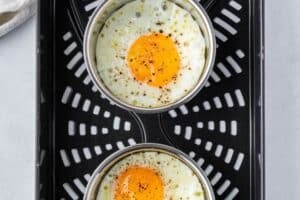 Cooked eggs in the air fryer basket.