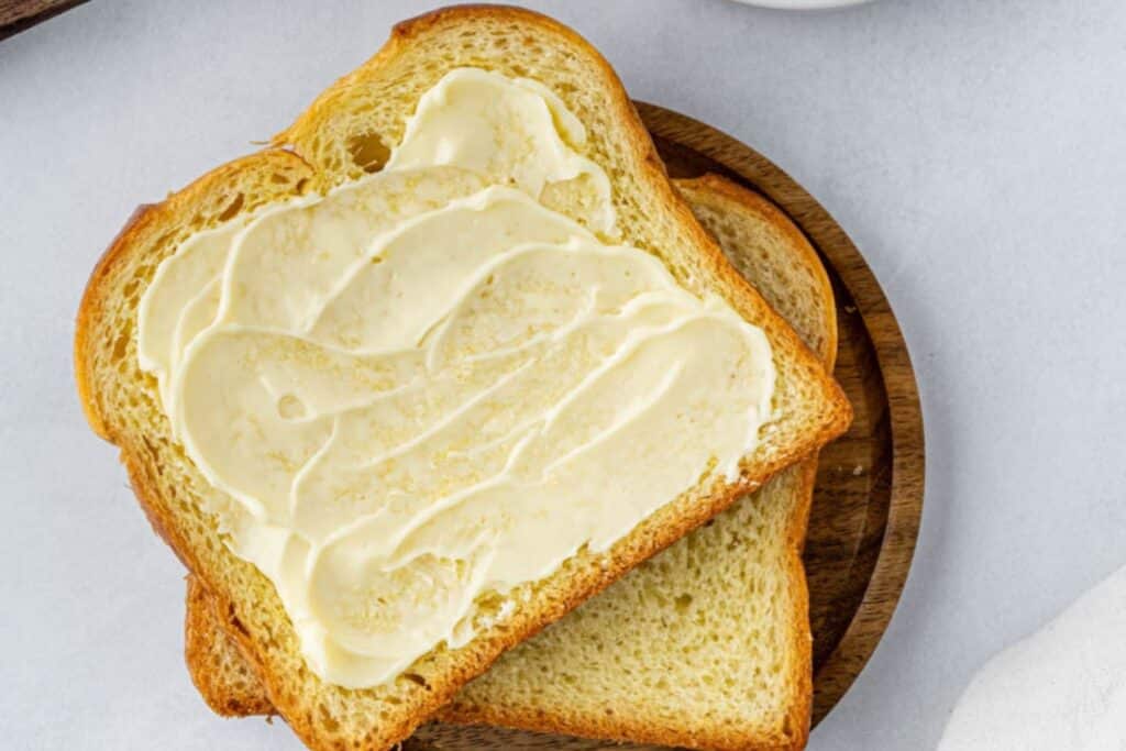 Spreading butter on bread.