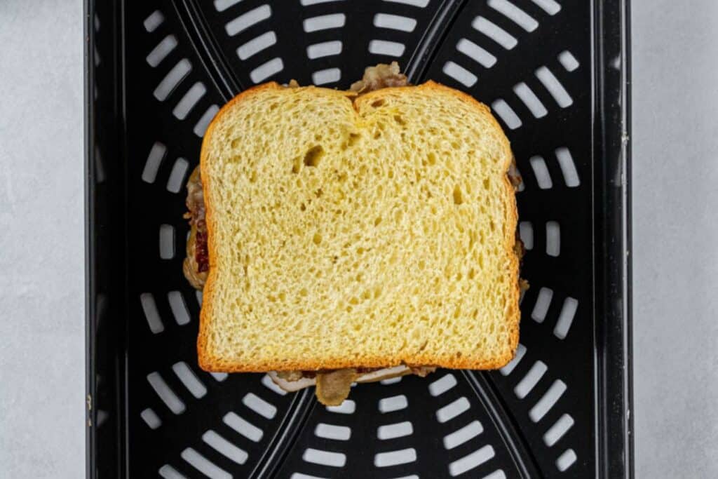 Uncooked turkey sandwich in the air fryer.