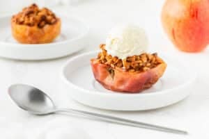 Two air fryer baked apples, one with vanilla ice cream.