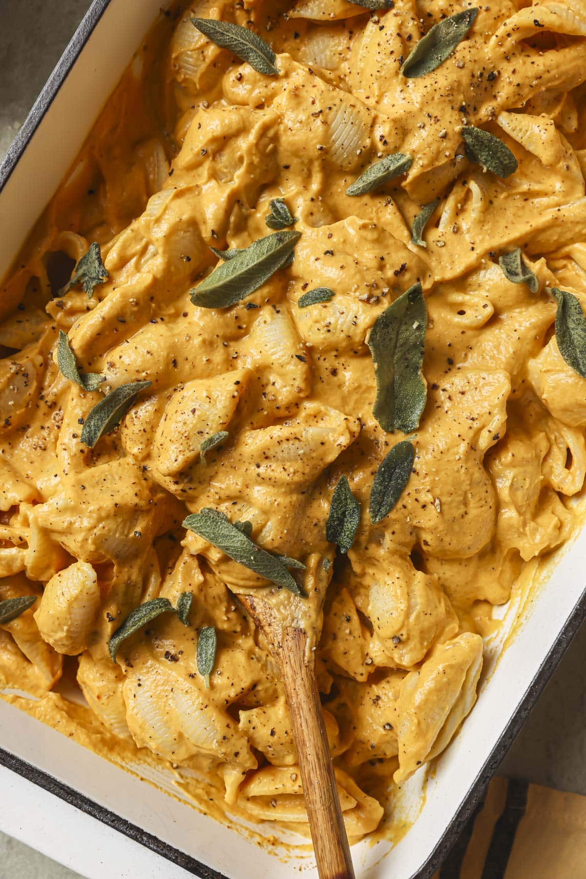 Pumpkin baked feta pasta in a white casserole dish.