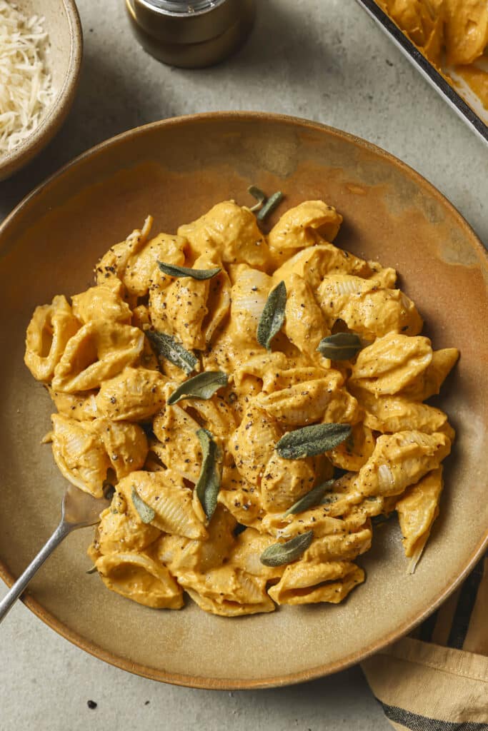 Pumpkin baked feta pasta in a bowl with fresh sage.