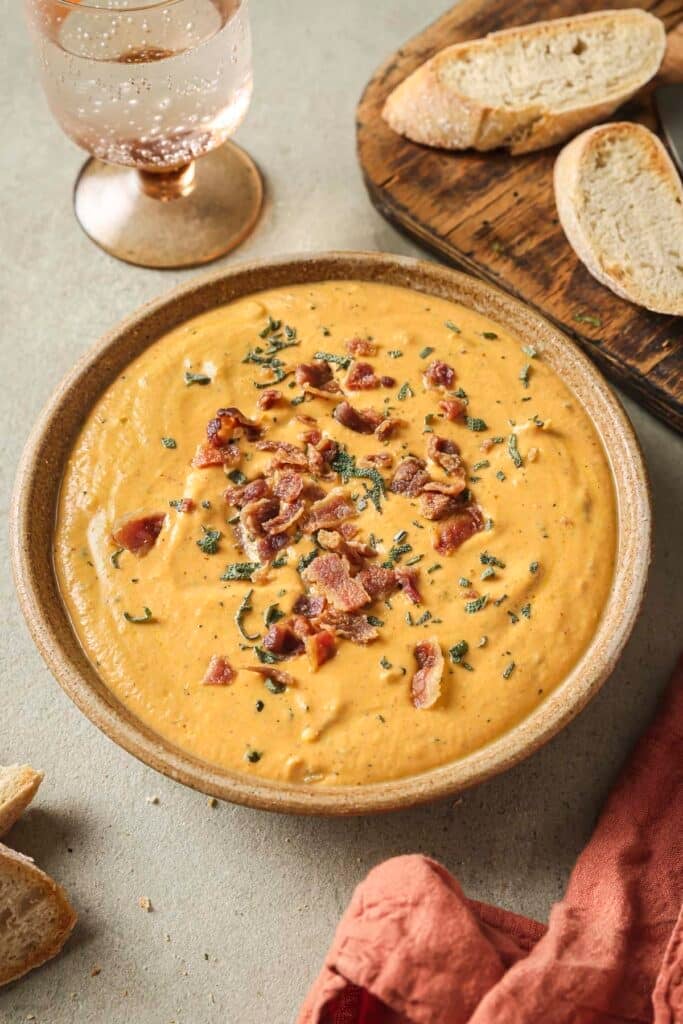 Savory pumpkin dip topped with bacon and sage.