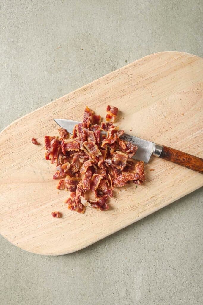 Bacon diced on a cutting board.