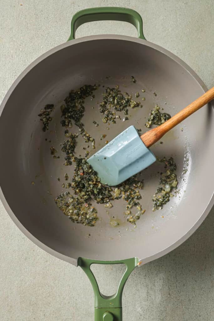 Sautéing shallots and sage in a skillet.