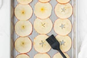 Apple slices on a baking sheet.