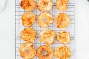Allowing apple chips to cool on a wire rack.