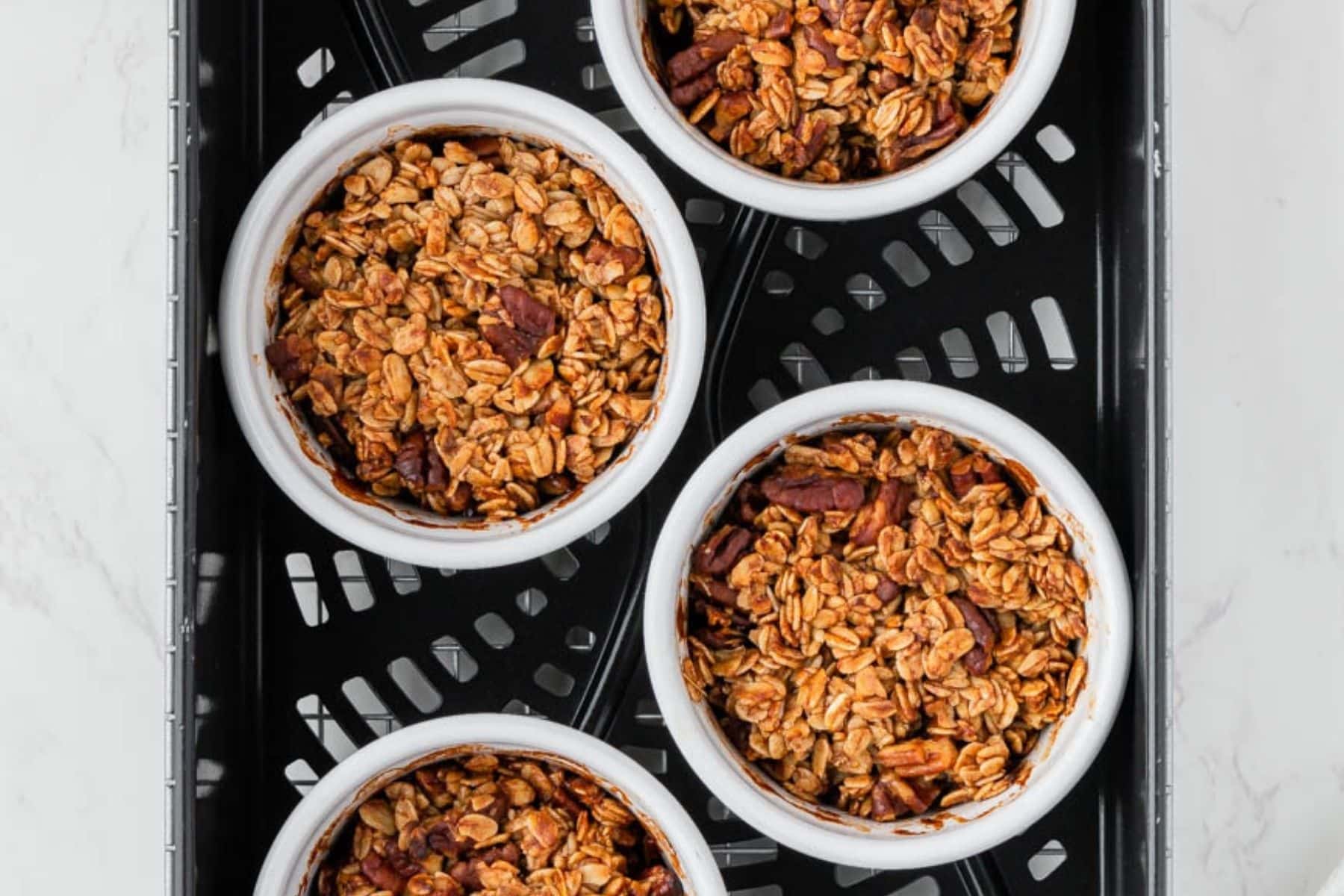 Air frying ramekins of apple crisp.