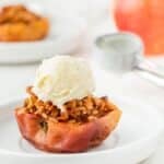 Air fryer baked apple with a scoop of vanilla ice cream.