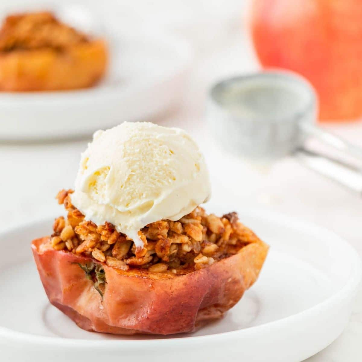 Air fryer baked apple with a scoop of vanilla ice cream.