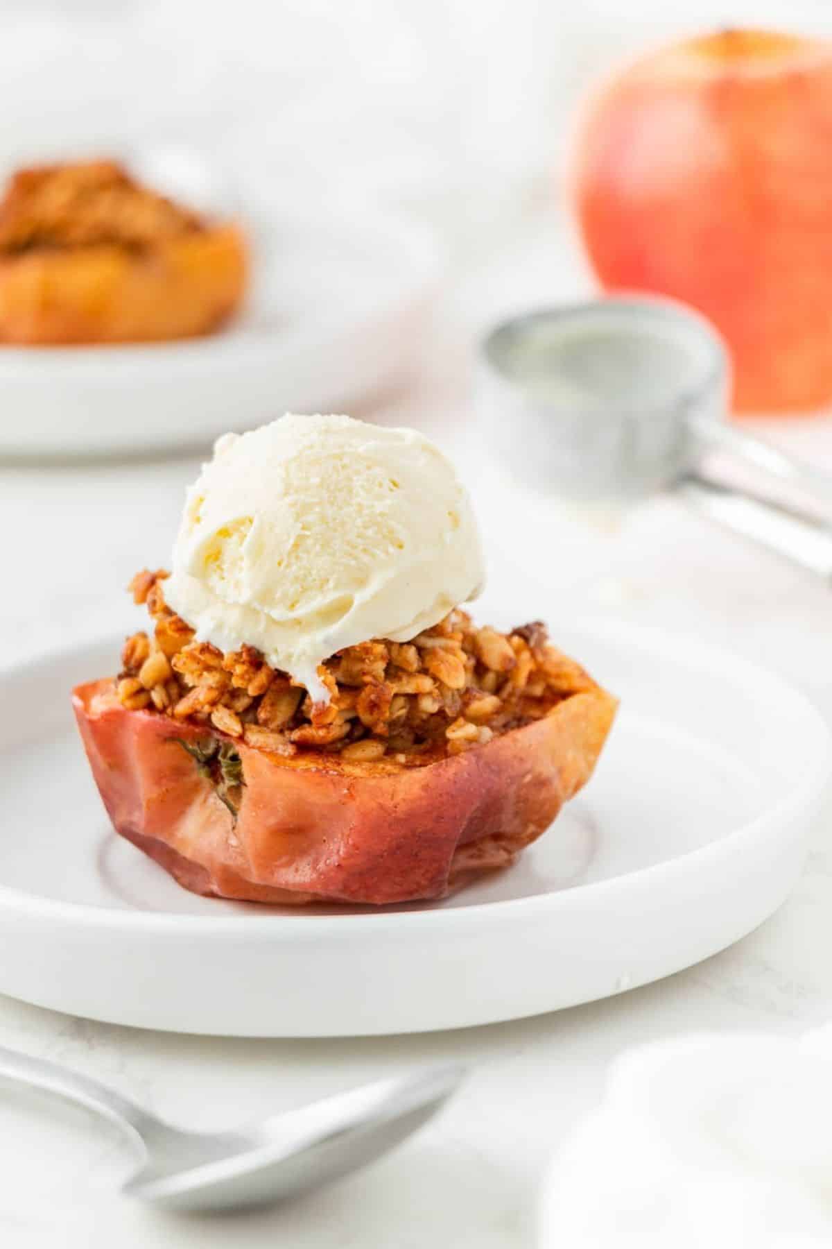 Air fryer baked apple with a scoop of vanilla ice cream.
