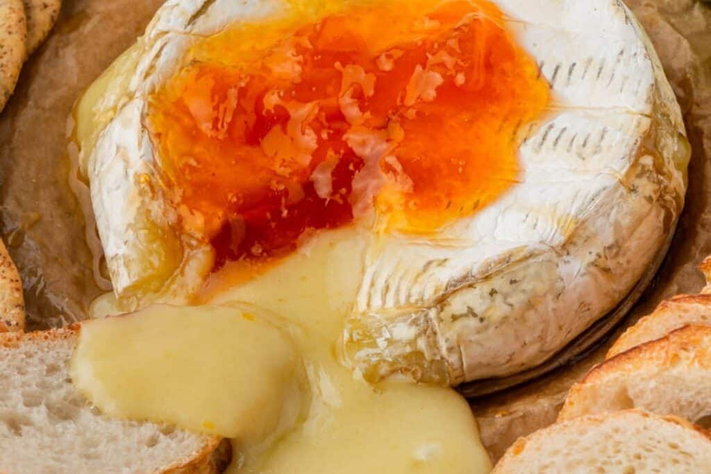 Cooked brie with apricot preserves.