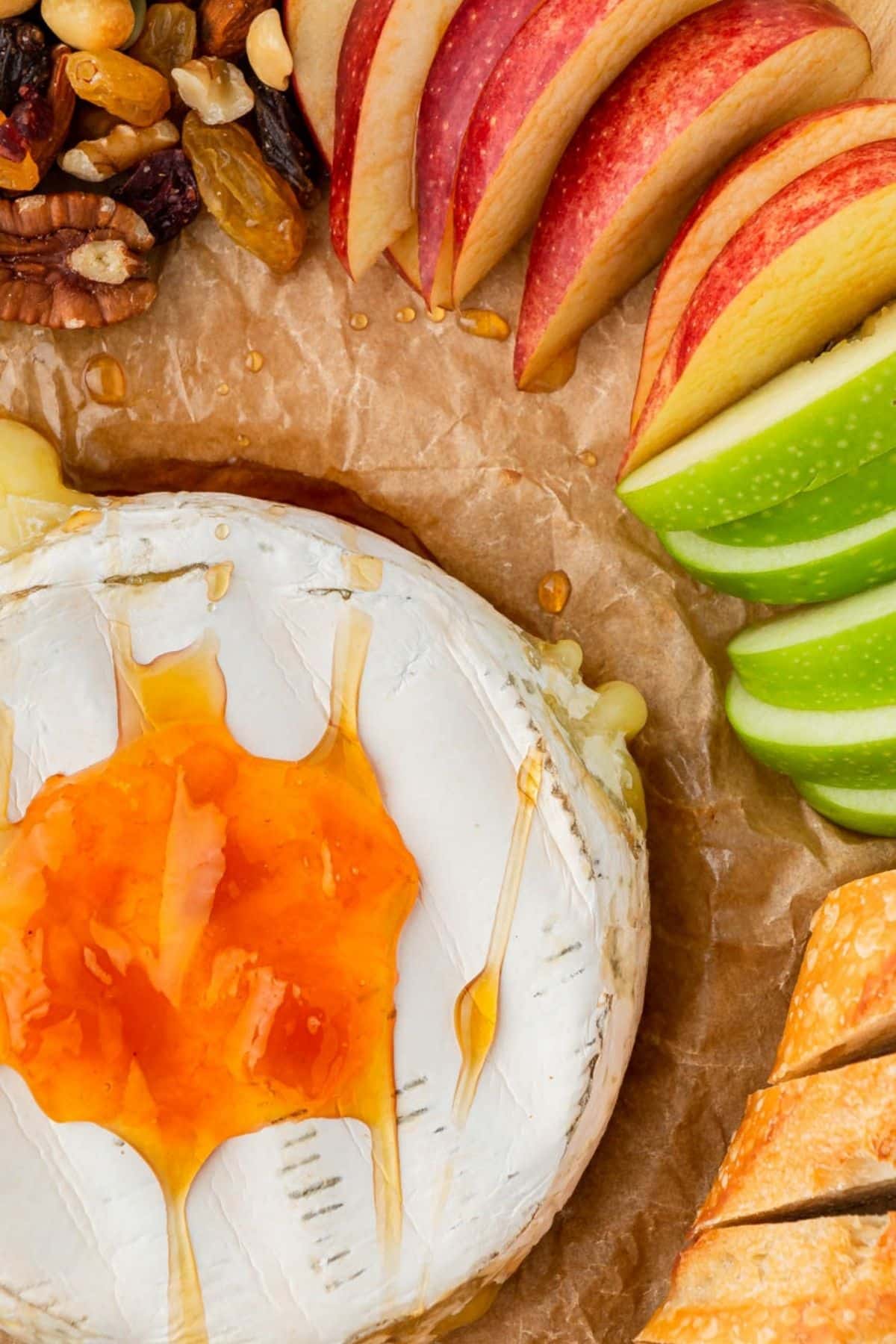 Air fryer baked brie served with apple slices and bread.