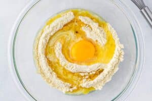 Making cornbread batter in a large bowl.