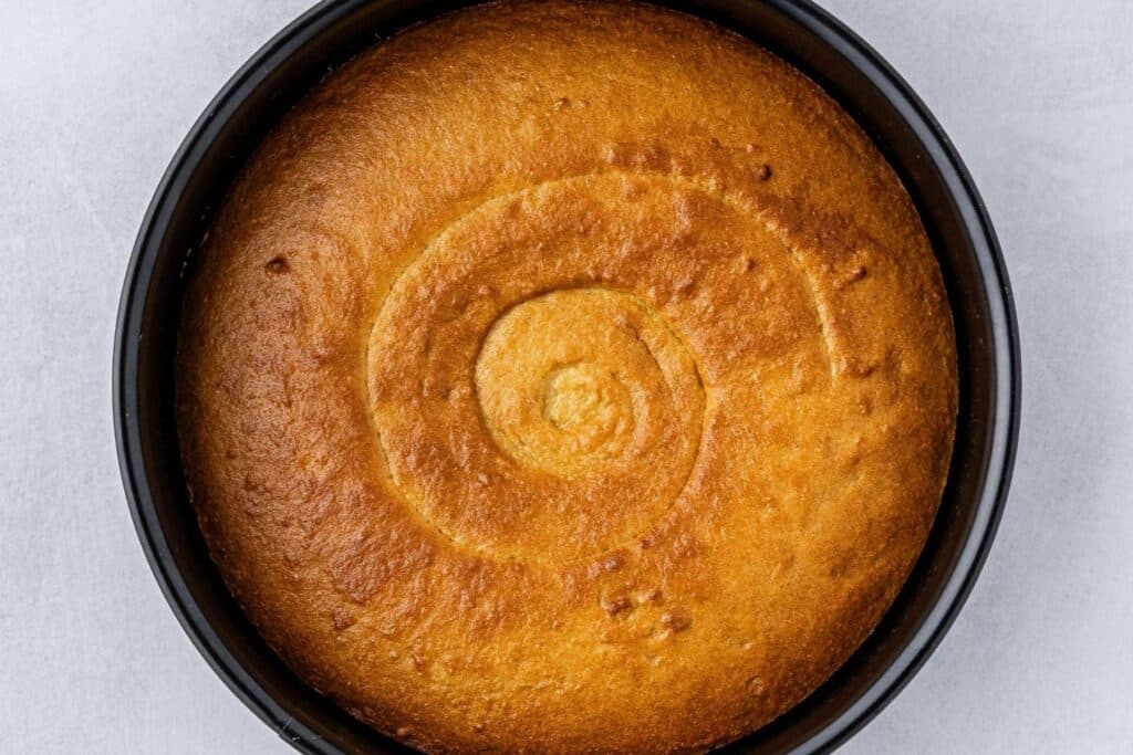 Golden brown air fryer cornbread in a springform pan.