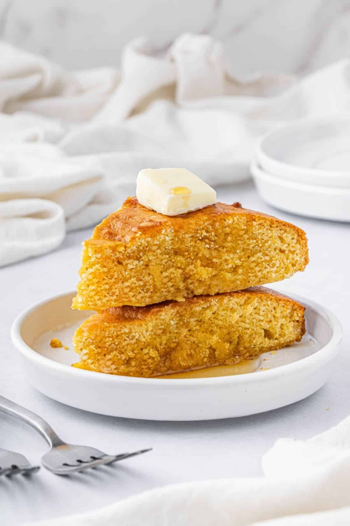 Two pieces of air fried corn bread on a plate.