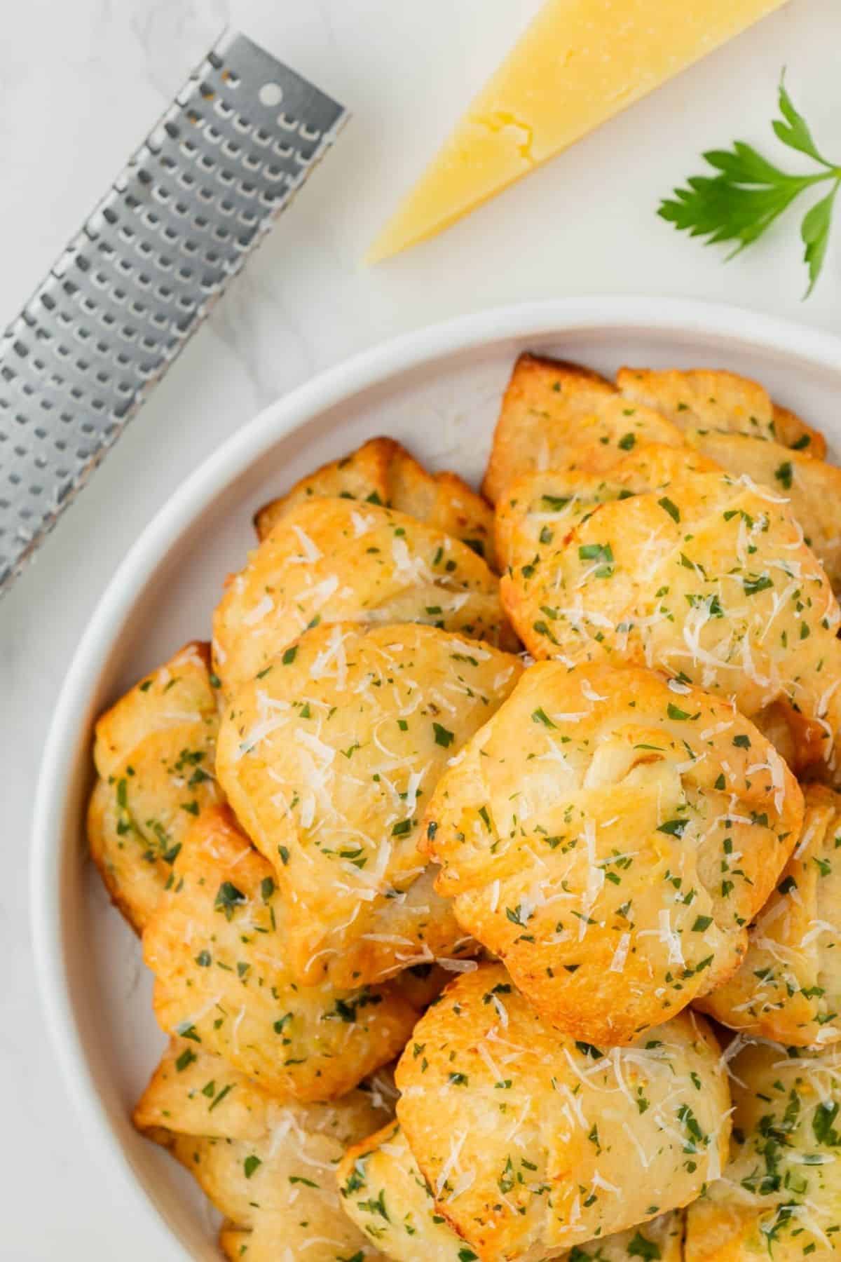 A dish full of air fried garlic knots.