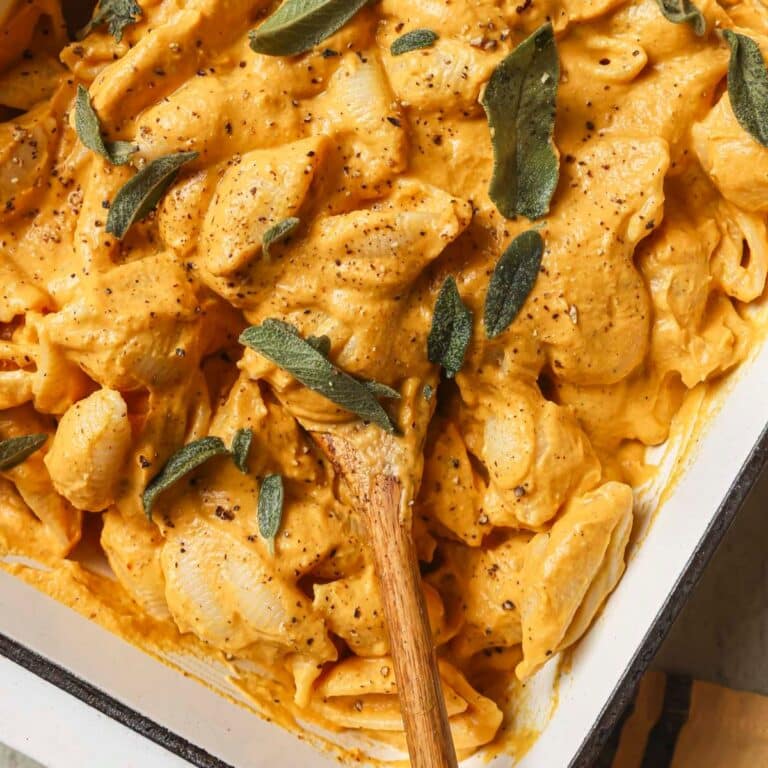 Pumpkin baked feta pasta in a white casserole dish.