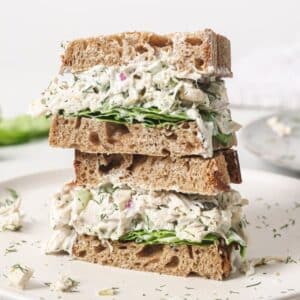 Two dill pickle chicken salad sandwiches stacked.