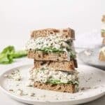 Two dill pickle chicken salad sandwiches stacked.