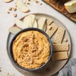 Pumpkin pie dip served with graham crackers and apple slices.