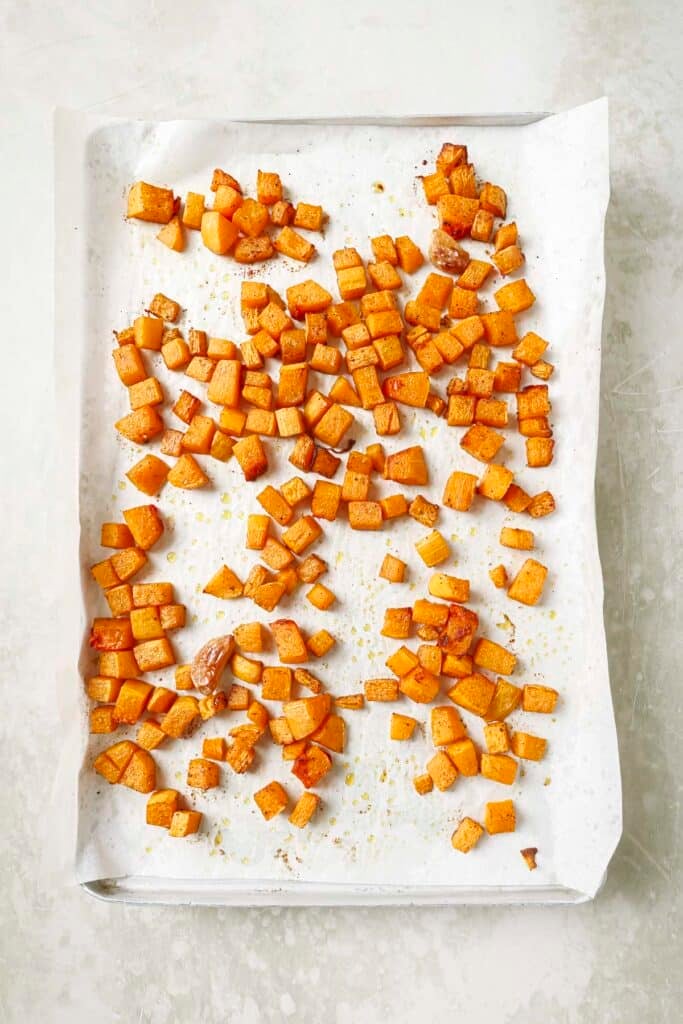 Roasted butternut squash on a sheet pan.