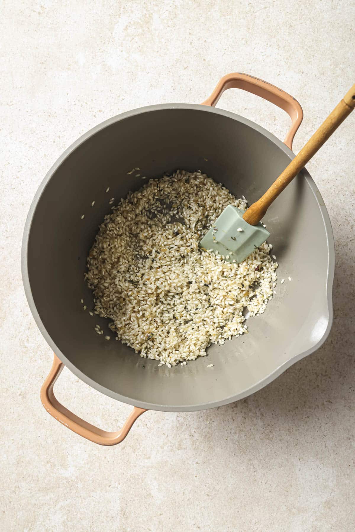 Toasting arborio rice in a large pot.