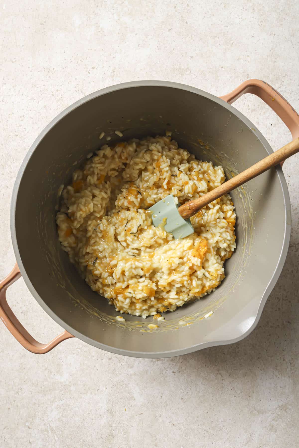 Stirring butternut squash into risotto.