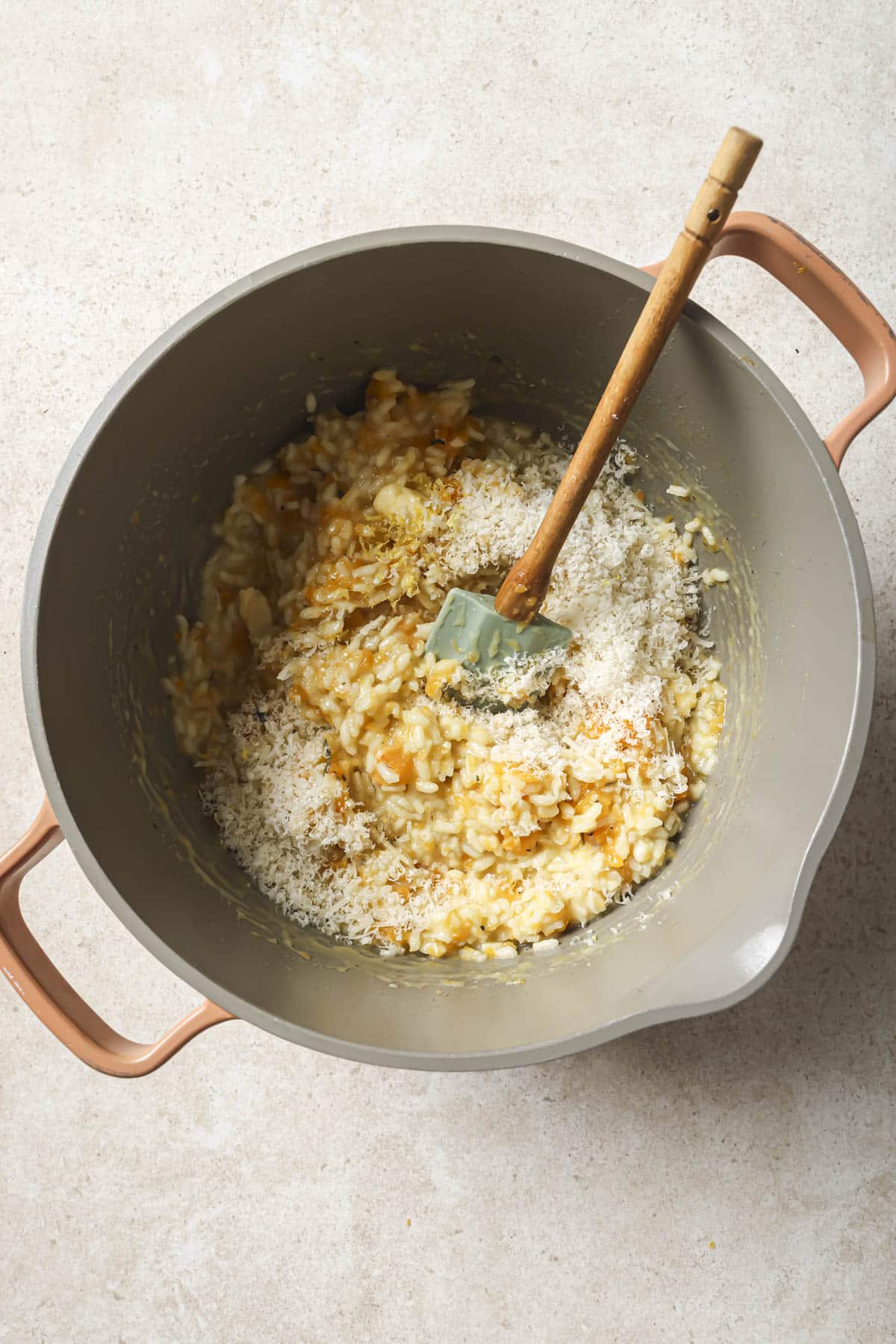 Stirring in parmesan cheese, butter and lemon zest.