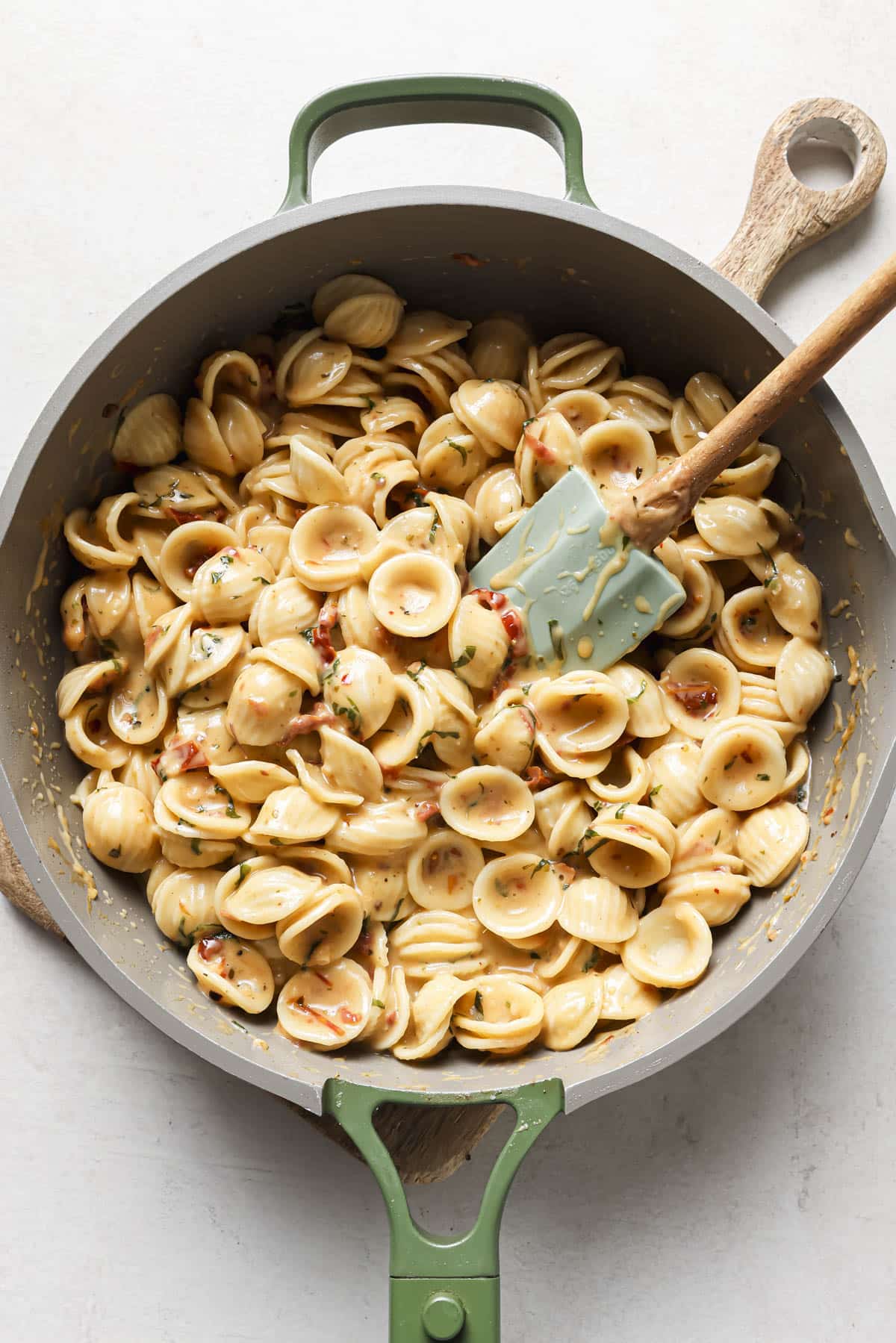 Stirring pasta with sauce.
