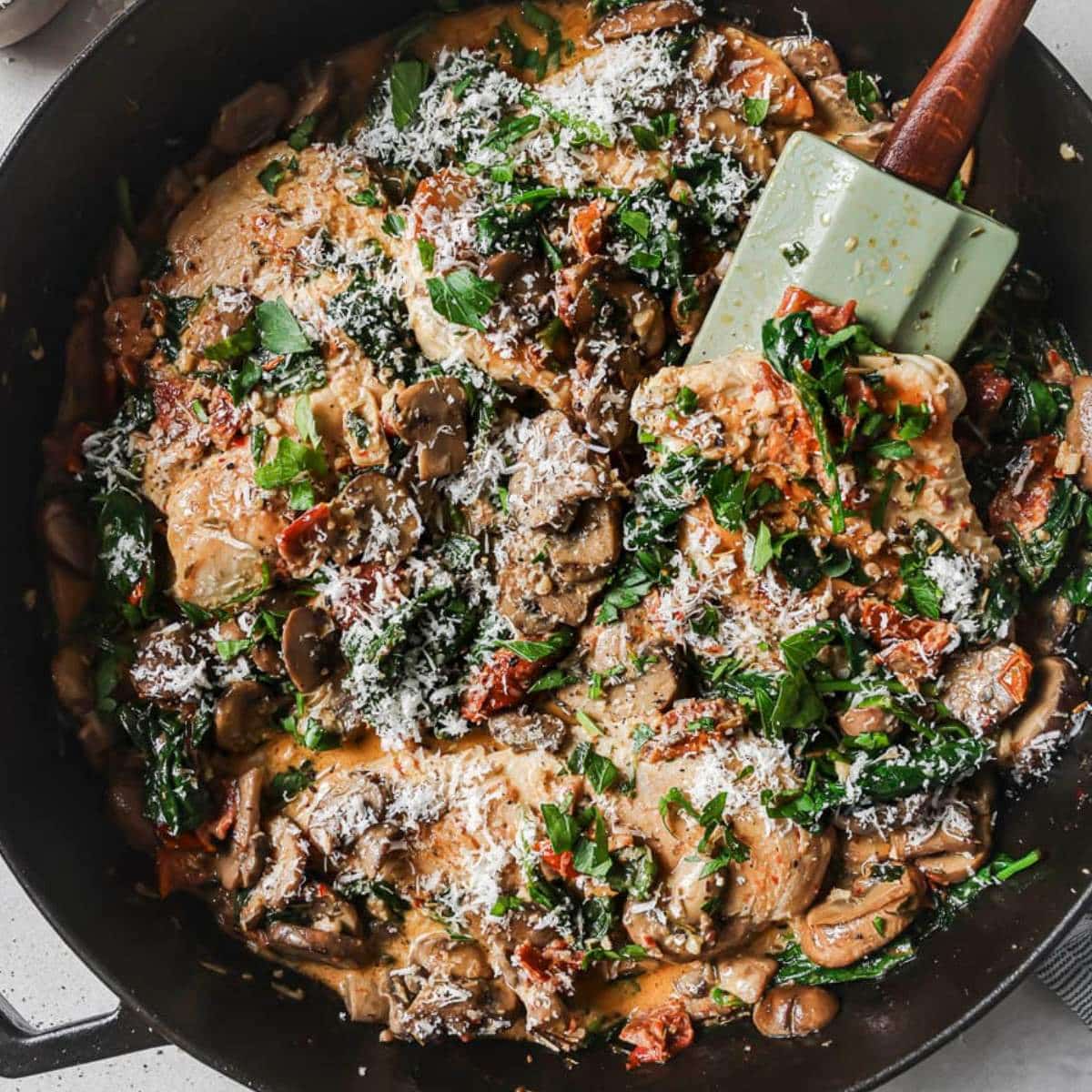 Mushrooms and chicken in a skillet.
