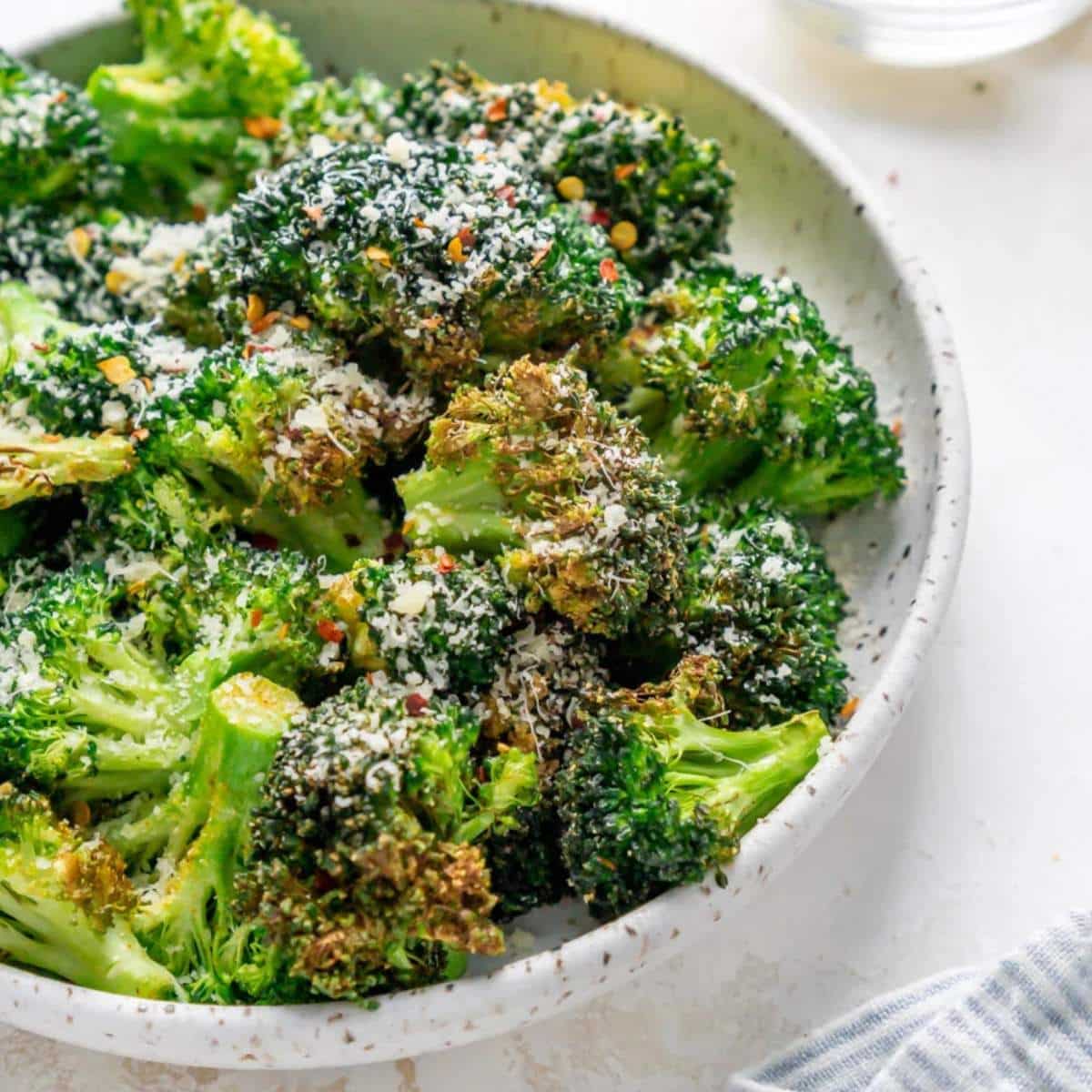 Air fryer broccoli in a white bowl.