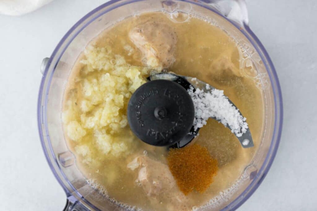 Making tahini sauce in a food processor.