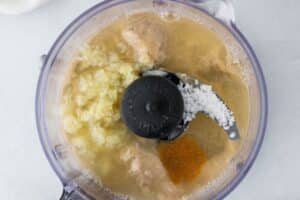Making tahini sauce in a food processor.