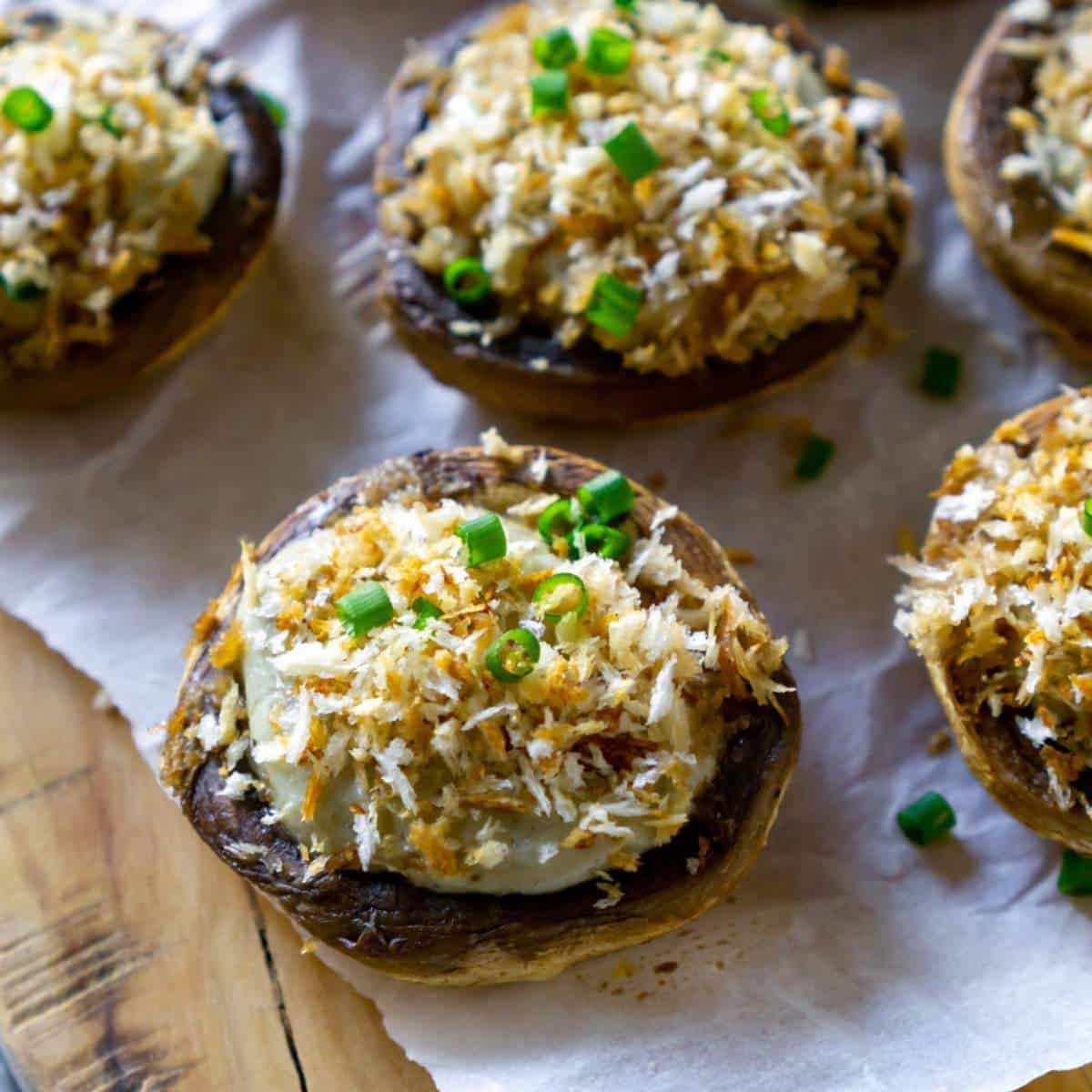 Blue cheese stuffed mushrooms on a wood tray.