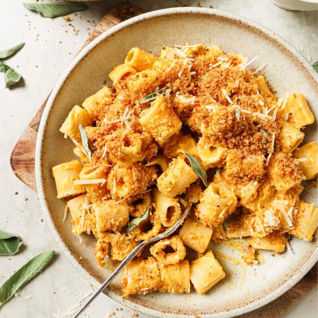 Butternut squash pasta on a plate with a fork.