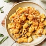 Butternut squash pasta on a plate with a fork.