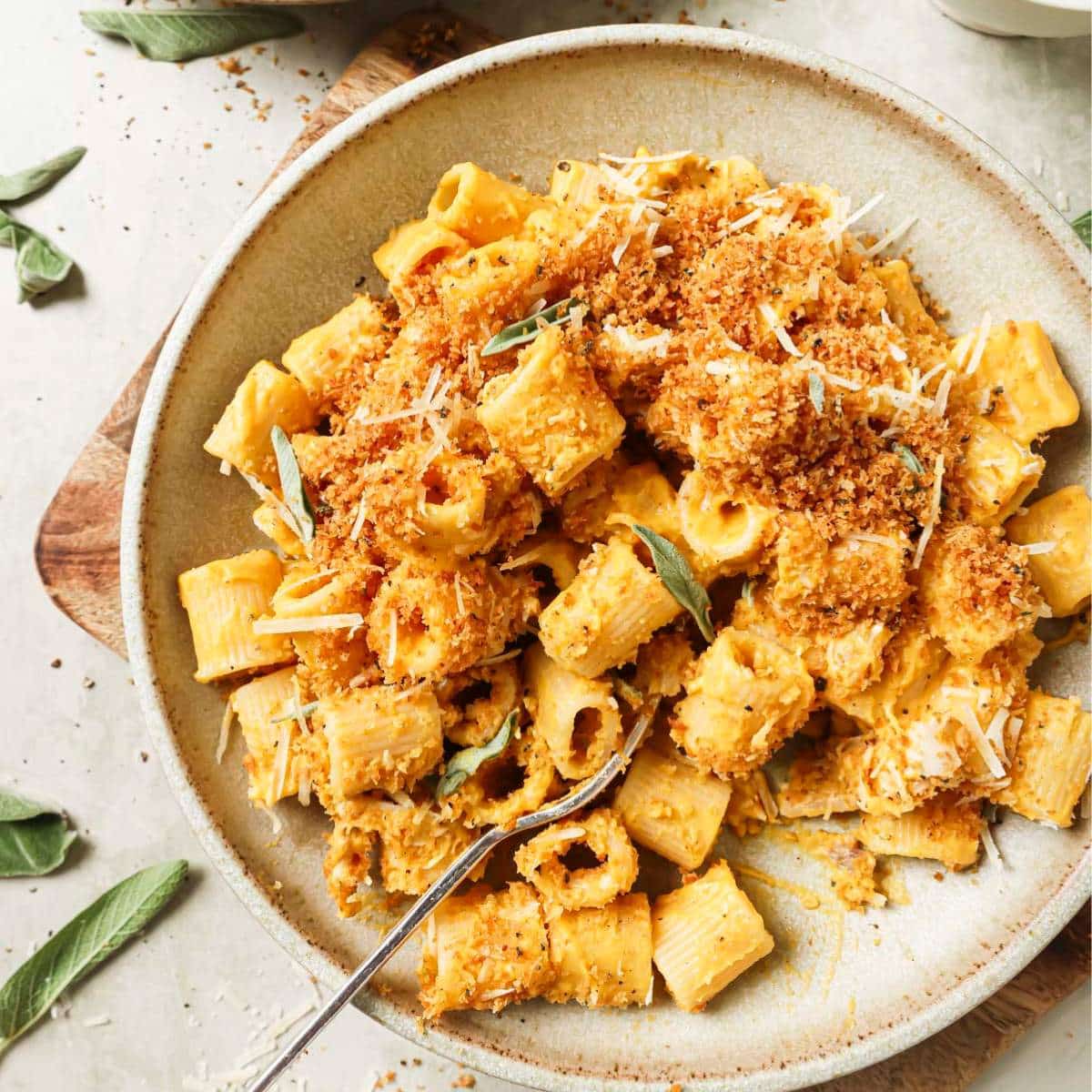 Butternut squash pasta on a plate with a fork.