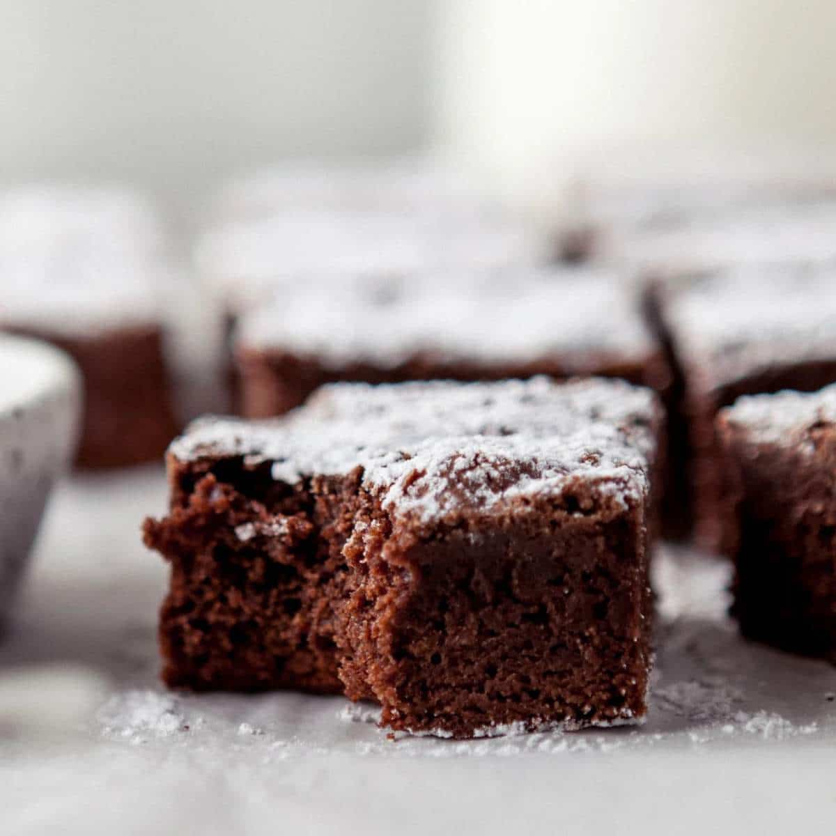 Dark chocolate brownies dusted with powdered sugar.
