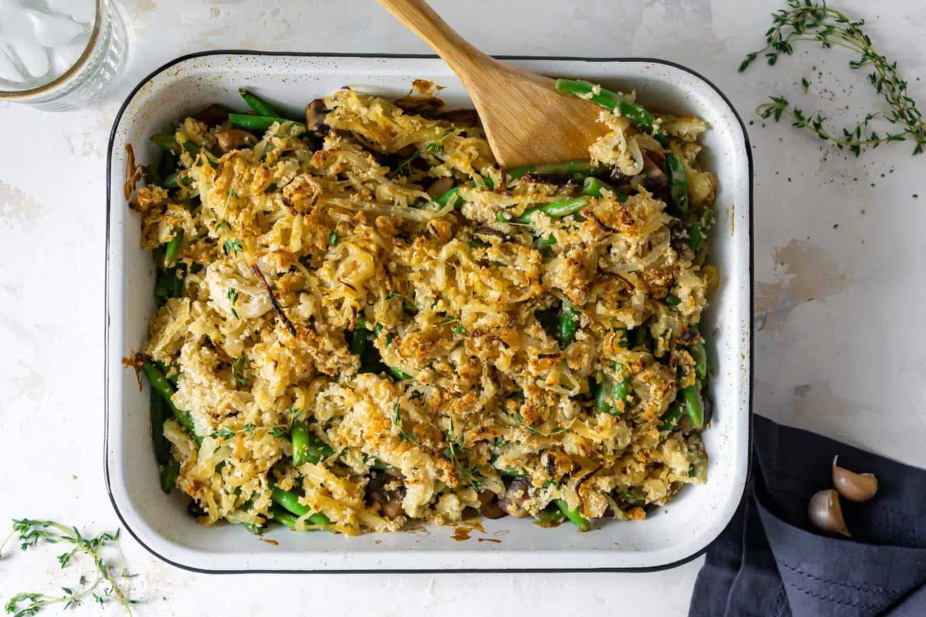 Green bean casserole in white baking dish.