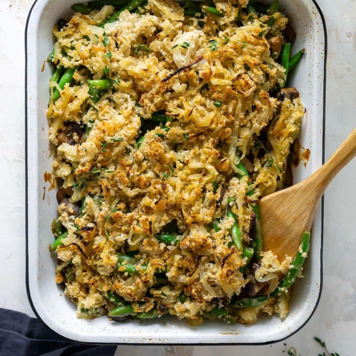 Green bean casserole in white baking dish.