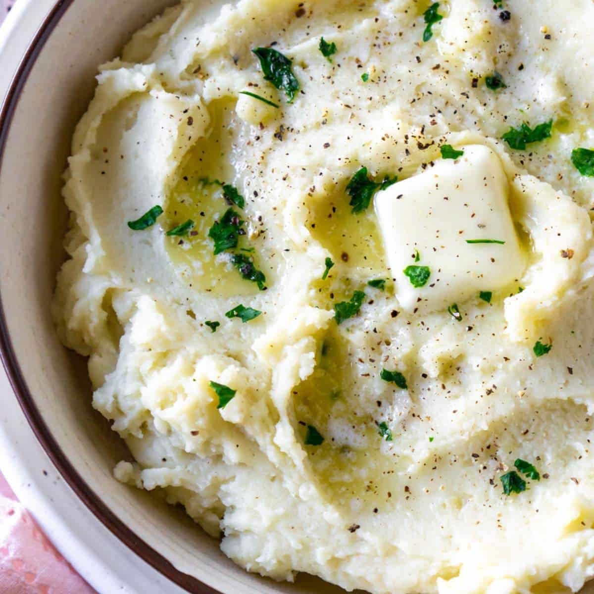 Garlic mashed potatoes in a white bowl.
