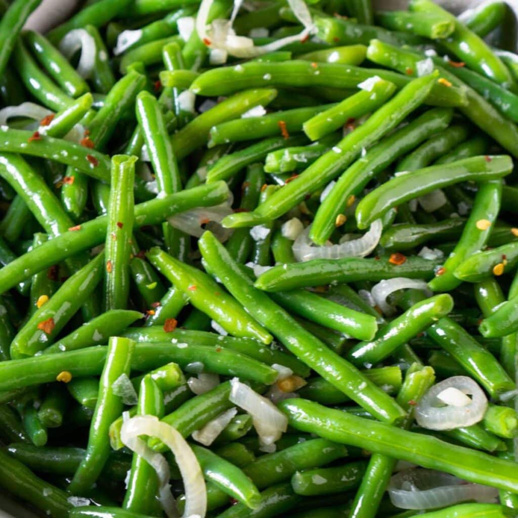 Sautéed green beans in a pan.