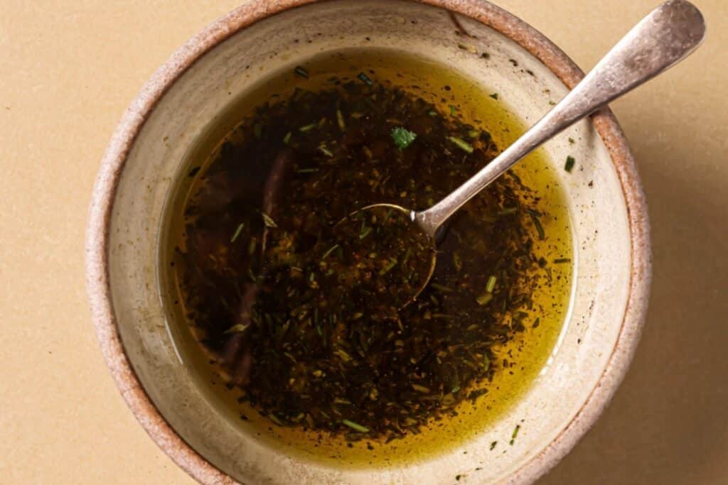 Combining oil and spices for air fryer steak bites.