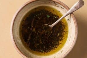 Combining oil and spices for air fryer steak bites.