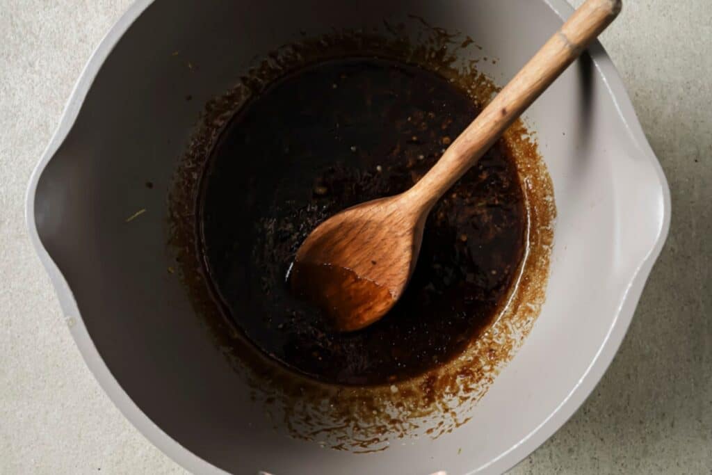 Mixing sauce in a bowl.