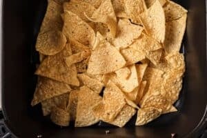 Tortilla chips in the air fryer basket.