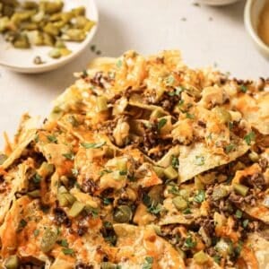 A plate of air fryer nachos with fixins.