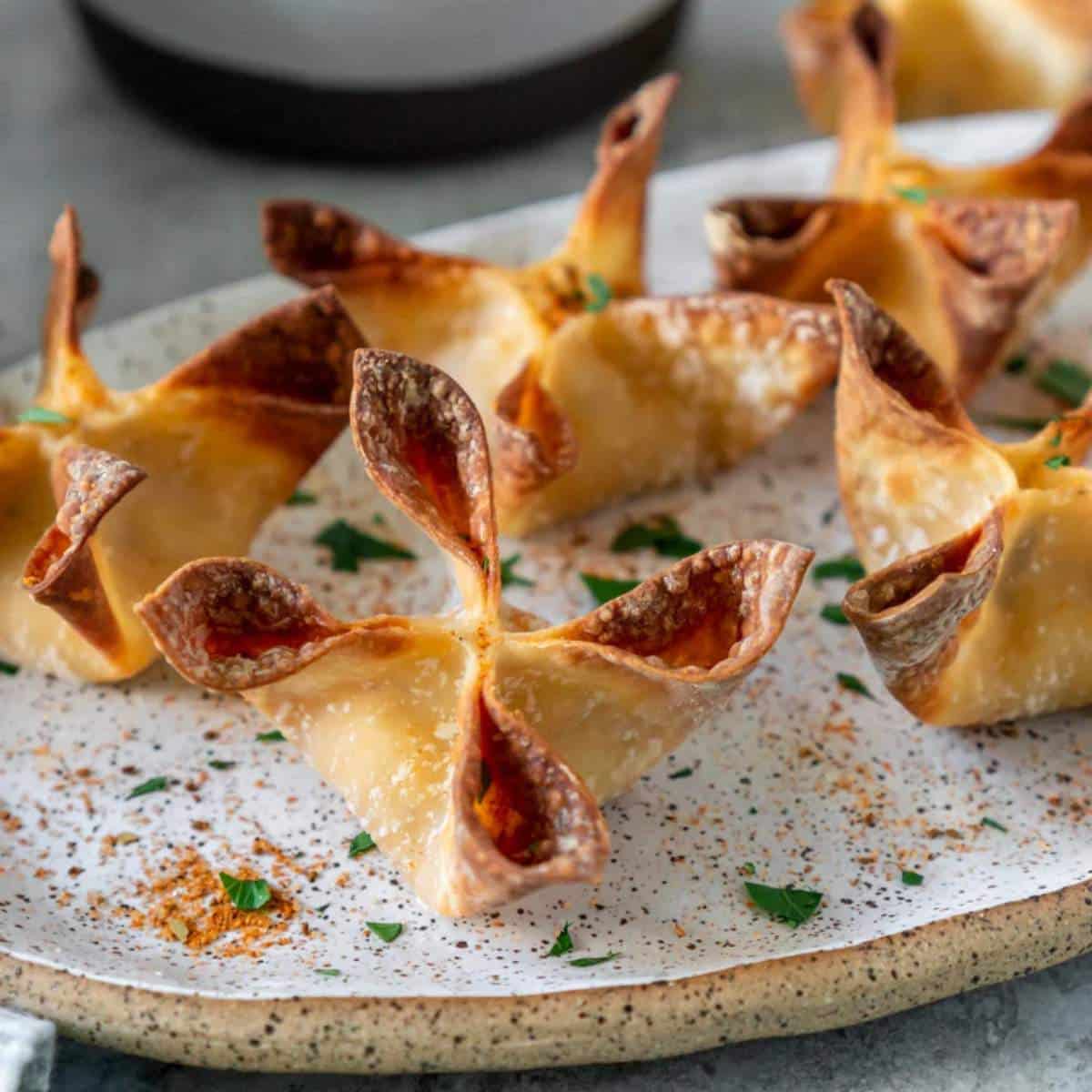 Air fryer crab Rangoons on a serving plate.